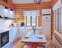 a kitchen with wooden cabinets and a dining table